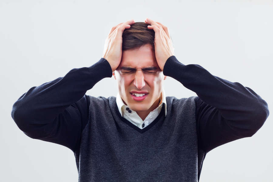 Man-with-a-headache-that-can-be-relieved-by-a-chiropractor-2.jpg