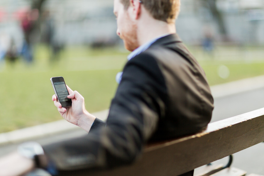 Man-looking-down-at-his-cell-phone.jpg